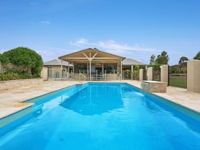 A family friendly pool design with a Vogue self cleaning pool and water wall feature